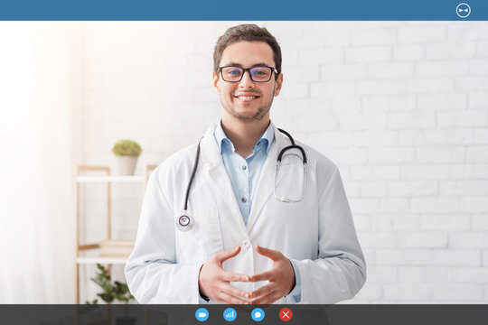 Health and medical blog. Smiling male doctor in white coat and glasses in interior, free space