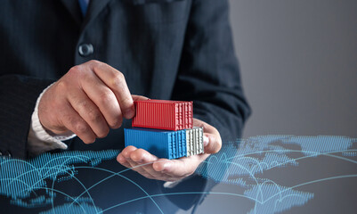Businessman holding shipping containers against world trade map. Global trade, logistics, and...