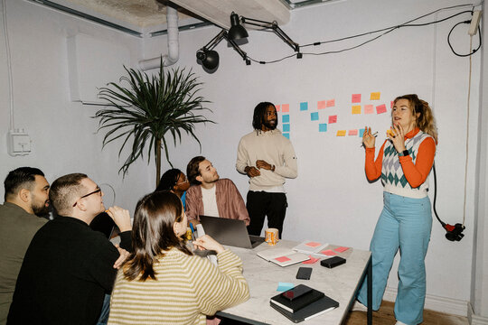 Female business professional planing strategies in meeting with colleagues at office