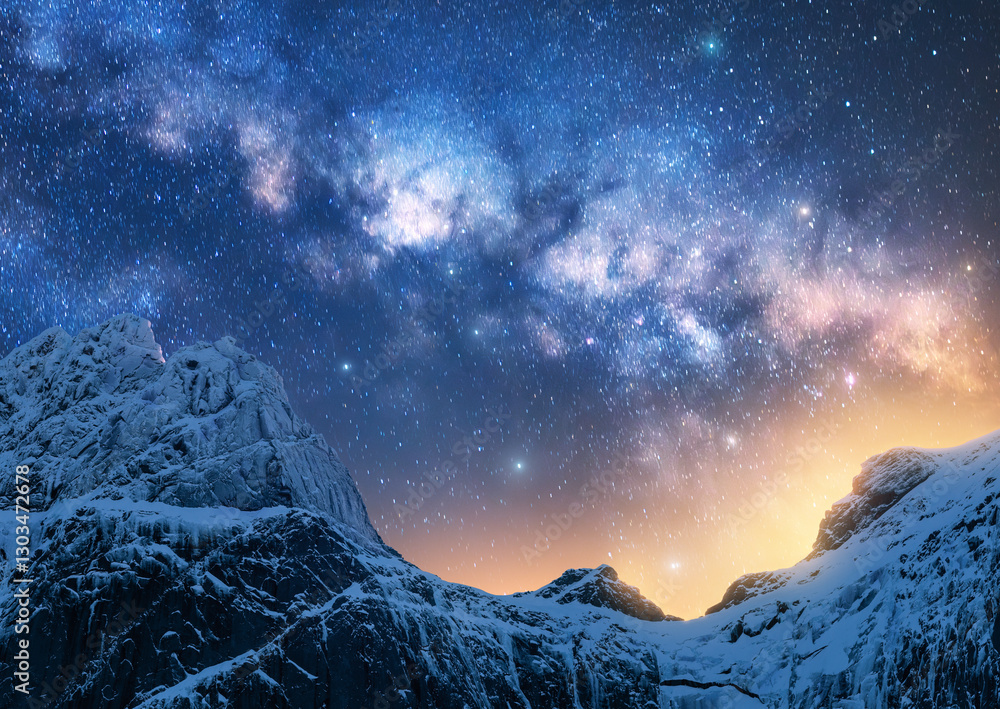 Wall mural glowing milky way over the beautiful mountains with snow covered peak at night in winter colorful la