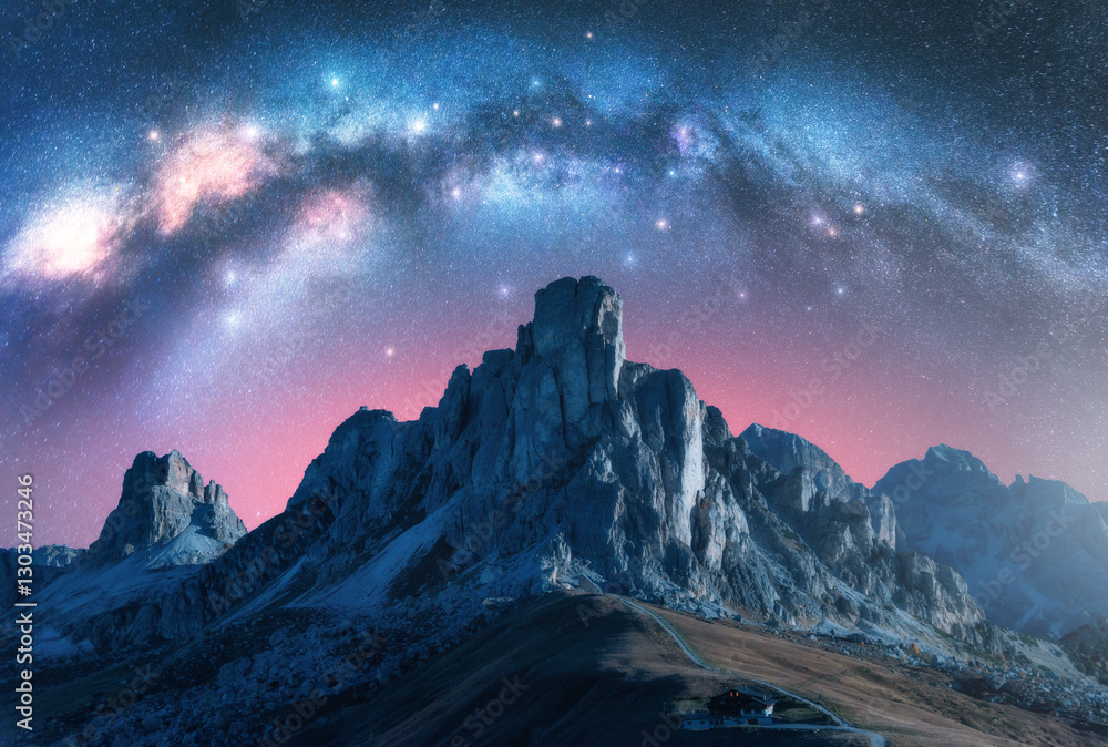 Wall mural milky way galaxy is shining over majestic alpine mountain range on summer night. paso giau, dolomite