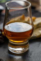 Whiskey and cheese pairing, tasting whisky glass and plate with sliced blue stilton and blue shropshire cheeses, Great Britain food and drink