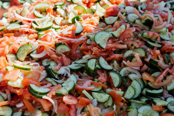 A detailed closeup view of a vibrant and colorful salad that showcases an array of fresh tomatoes,...