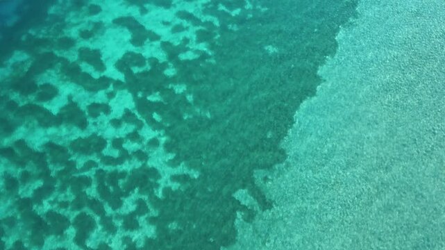 Aerial View of Crystal Clear Turquoise Water and Rocks in Lake Ohrid, North Macedonia, a Scenic Summer Travel Destination