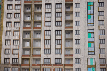 Fototapeta premium Urban Construction A Modern Building is Under Development in the Cityscape Area Nearby