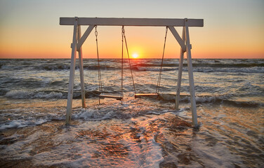 Waves Crashing Around Beach Swing at Sunrise