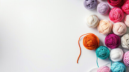 Colorful yarn balls arranged on a white surface ready for crafting and creative projects