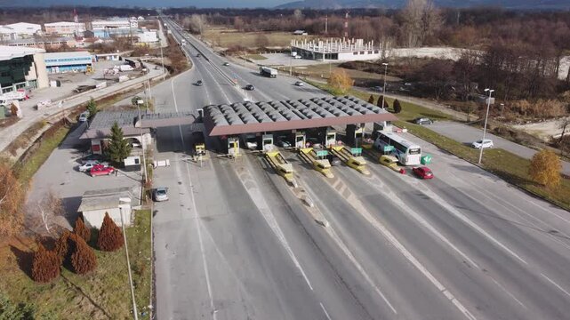 Aerial View of Cars and Trucks Passing Through a Toll Booth on a Highway