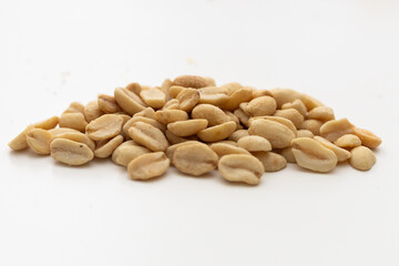 a handful of peanuts on a white table