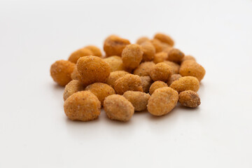 a handful of peanuts on a white table