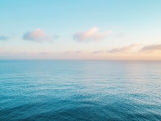 Fototapeta premium Serene Ocean View with Gentle Waves Under a Calm Sky at Sunset, Soft Pastel Colors Creating a Peaceful Atmosphere for Relaxation and Reflection