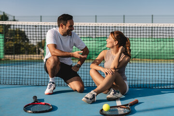 Young couple playing tennis outdoors enjoying a fun summer game