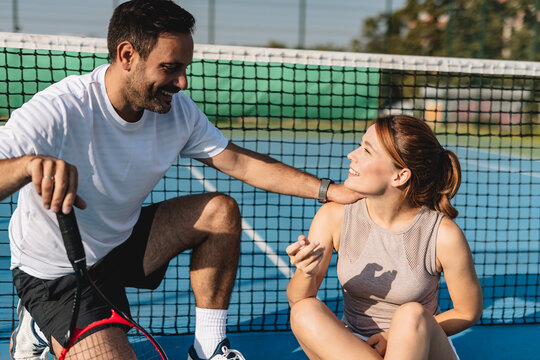 Young couple playing tennis outdoors enjoying a fun summer game
