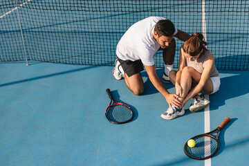 Young couple playing tennis outdoors enjoying a fun summer game