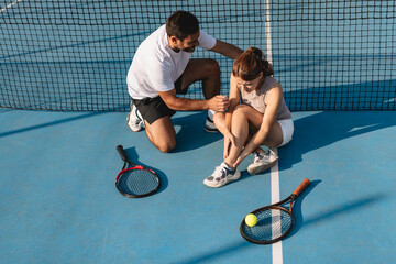 Young couple playing tennis outdoors enjoying a fun summer game