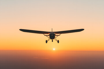 Fototapeta premium Airplane flying towards the sunset, silhouetted against a vibrant sky. The aircraft is positioned center frame, heading directly towards the viewer.