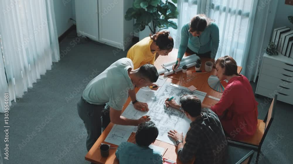Poster top view of civil engineer team writing at blueprint at meeting table with color palettes. group of 