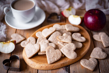 Rye biscuits for breakfast. Heart-shaped cookies on a wooden board. Romantic cookies for Valentine's day. Close-up