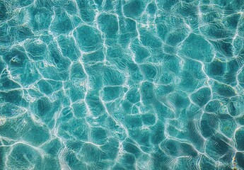 Tranquil Aquatic Texture of Clear Blue Water with Delicate Ripples and Sunlight Reflections Creating an Inviting Serene Environment