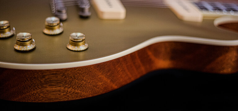 Close-up of a classic Goldtop guitar with P90 pickups, showcasing its vintage design, warm tones, and iconic single-cutaway body. Perfect for blues, rock, and jazz themes with a timeless aesthetic