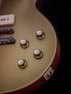 Close-up of a classic Goldtop guitar with P90 pickups, showcasing its vintage design, warm tones, and iconic single-cutaway body. Perfect for blues, rock, and jazz themes with a timeless aesthetic