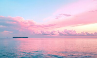 Obraz premium Tranquil pastel sunset over calm ocean waters with gentle waves and distant islands under a colorful sky filled with soft clouds and serene hues.