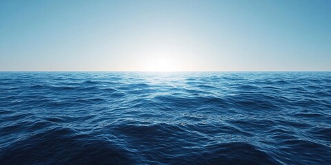 Obraz premium A vast expanse of blue ocean with the sun shining in the distance