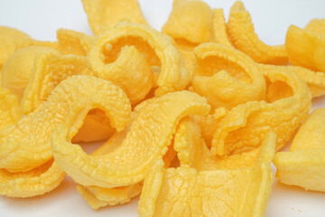 Close up of traditional yellow crackers isolated on white background.Traditional food concept.Typical Indonesian crackers.For graphic design or banner background