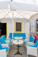 White chairs and table with umbrella setting