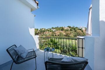 a close up image of a private balcony terrace overlooking a mediterranean golf course