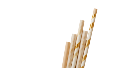 A stylish golden and white paper straw, symbolizing eco-conscious choices, isolated on a neutral background with a clean clipping path, ideal for eco-friendly campaigns, packaging, and beverage-relate