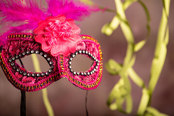Carnival mask, beautiful carnival mask surrounded by serpentine, selective focus.