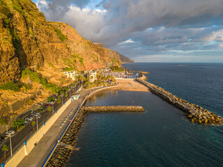 Obraz premium Portugal, Madeira, Calheta, high angle view of the coastal town at sunset. 