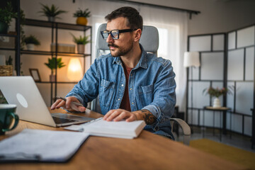 focused concentrated man work on laptop from home office