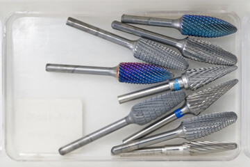 In the dentist's office Collection of Metal Burrs in Clear Container