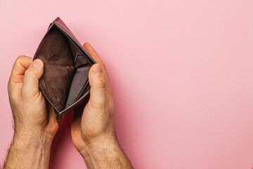 Wallet held open displaying emptiness amidst financial struggle and crisis