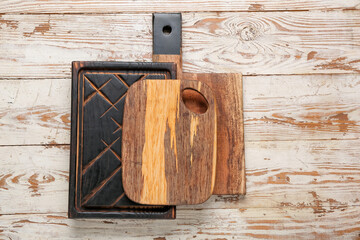 Different wooden cutting boards on white table