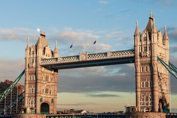 Tower Bridge in London at sunset with moon behind the clouds