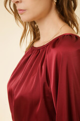 Fototapeta premium Female model in red silk blouse. Classic and timeless simple fashion.