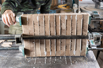 The carpenter glues the bars together