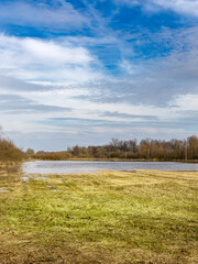 Fototapeta premium Field with a body of water in the foreground