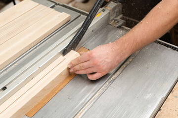 Safe operation: the carpenter pushes the wooden part with a push rod, not with his hands.