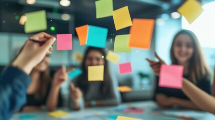 Businesswomen are having a meeting and planning strategy using colorful sticky notes on a glass wall in a modern office, working together on a new project
