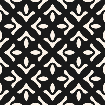 Fototapeta Abstract geometric seamless pattern. Simple vector floral ornament with ethnic folk motif. Black and white background texture with flower silhouettes, leaves. Repeated mosaic design for print, decor