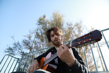 Man Plays Music With Classical Guitar Inexpensive Instrument