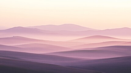 Obraz premium Rolling hills and mountains are veiled in a purple morning haze