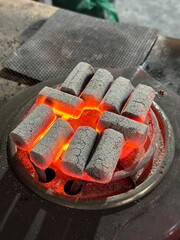 Fire burning from coconut charcoal briquette for business production	
