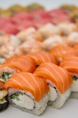 Close up of sushi with salmon, tuna, shrimp and cream cheese