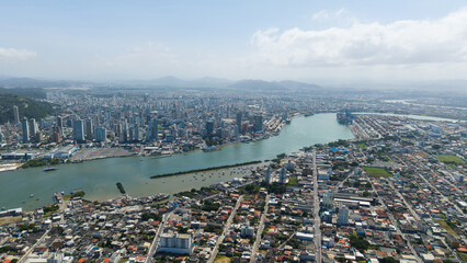 Panoramic photograph of Itajaí, a coastal city in southern Brazil, highlighting its urban landscape, port, and connection to the Atlantic Ocean.