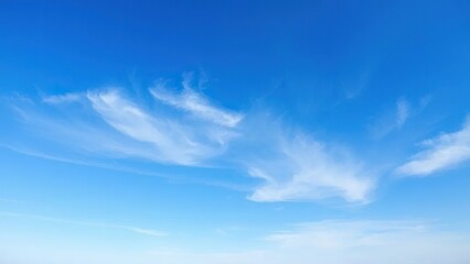Obraz premium Blue sky with a few wispy clouds in the distance, serene, vast, airy